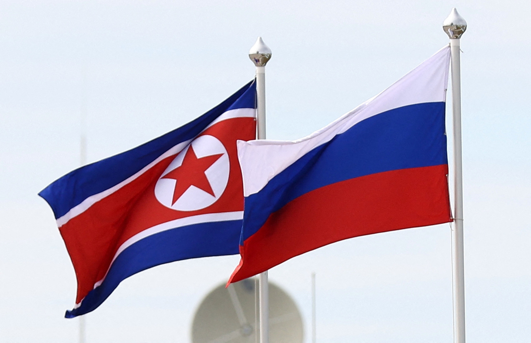 FILE PHOTO: Russian and North Korean flags fly at the Vostochny Сosmodrome, the venue of the meeting between Russia's President Vladimir Putin and North Korea's leader Kim Jong Un, in the far eastern Amur region, Russia, September 13, 2023. Sputnik/Artem Geodakyan/Pool via REUTERS
